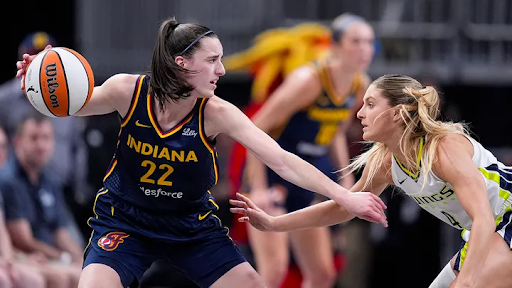 Image via Michael Conroy. Dallas Wings guard Jacy Sheldon (4) defends Indiana Fever guard Caitlin Clark (22) in the first half of a WNBA basketball game in Indianapolis, Sunday, Sept. 15, 2024