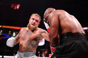 ARLINGTON, TEXAS — NOVEMBER 15: (L-R) Jake Paul and Mike Tyson fight during LIVE On Netflix: Jake Paul vs. Mike Tyson at AT&T Stadium on November 15, 2024 in Arlington, Texas. (Photo by Al Bello/Getty Images for Netflix © 2024)